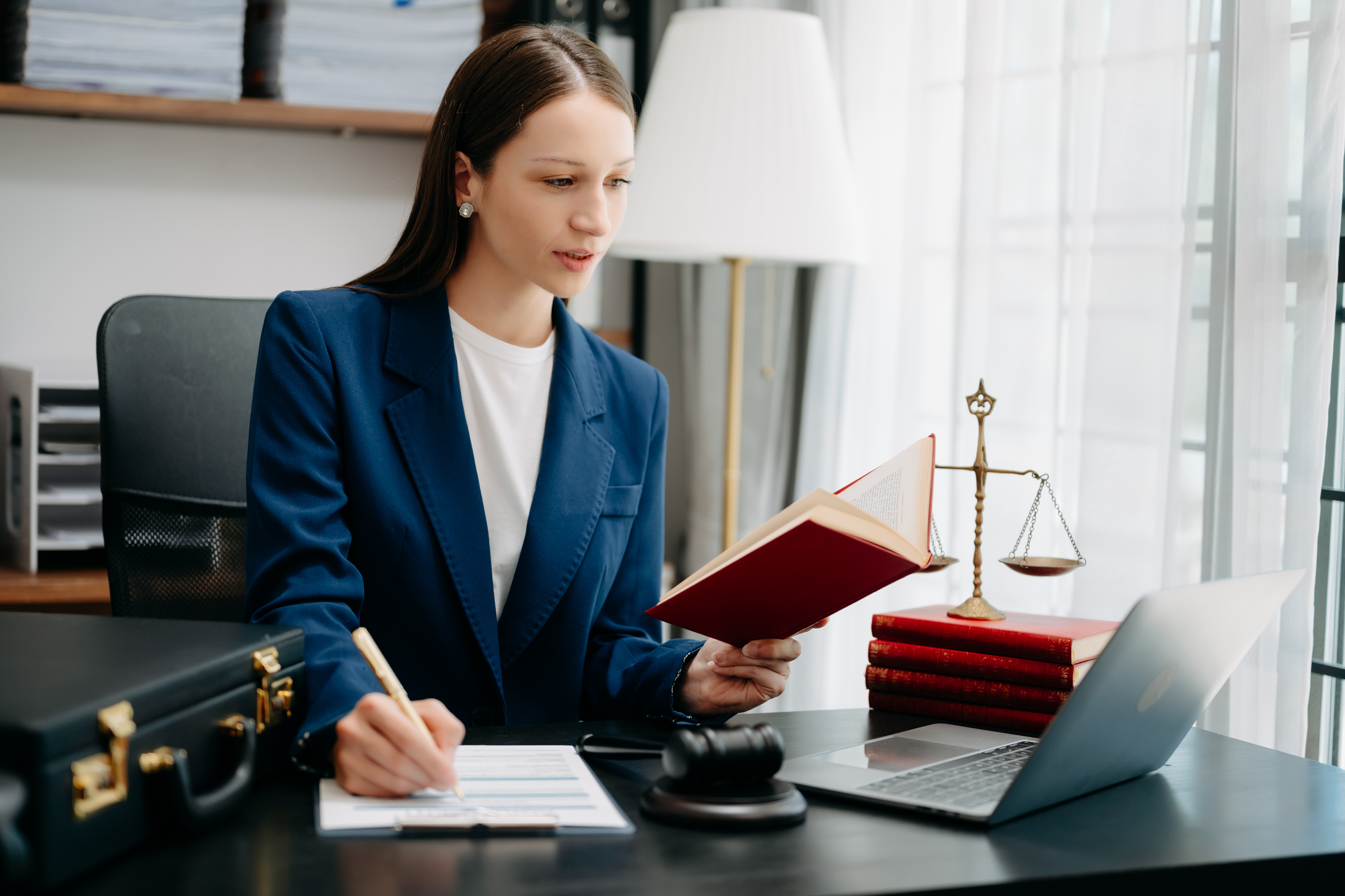 Solicitor reviewing legal documents at desk